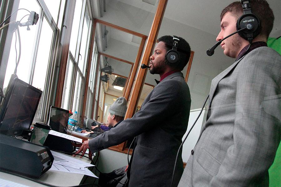 Communication majors at the University of Wisconsin Whitewater work with electronic media at the football game.