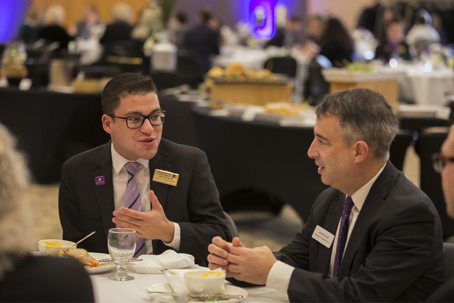 A student speaks with a politician.