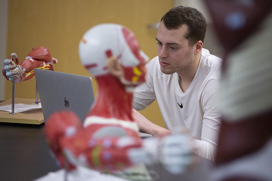 A student works on a laptop during an anatomy class.