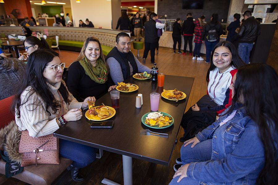 Students sit at a dining table.