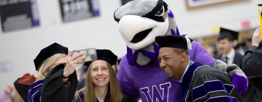 Two Whitewater graduates take a selfie with Willie