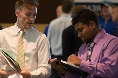 Jake Griffith, left, and mentor Benjamin Brotz walk the floor of CNH Industrial's plant in Sturtevant, Wisconsin.