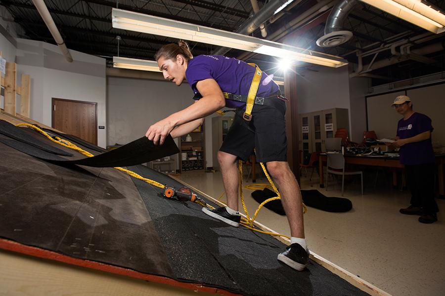 Connor Carrington ‘17, works on the original roofing workstation in the Ambrose Health Center